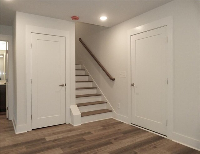 staircase with wood-type flooring