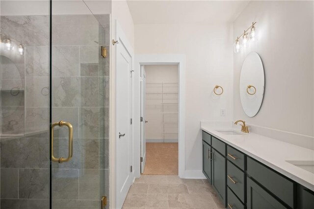 bathroom featuring tile patterned floors, vanity, and walk in shower