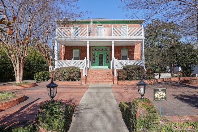 view of front facade featuring a balcony and covered porch