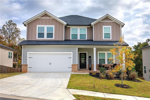 craftsman-style home featuring covered porch, a garage, and a front lawn