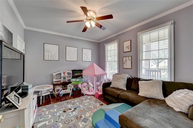 living room featuring crown molding, hardwood / wood-style floors, a healthy amount of sunlight, and ceiling fan