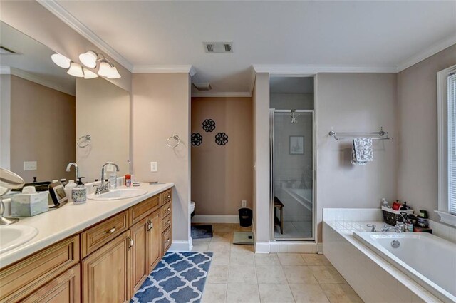 full bathroom featuring independent shower and bath, toilet, ornamental molding, vanity, and tile patterned flooring