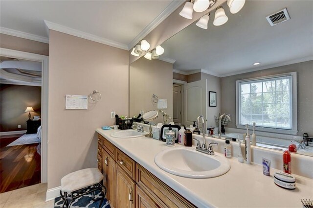 bathroom featuring vanity, tile patterned floors, ornamental molding, and a bath