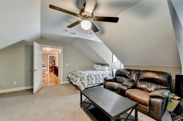 bedroom featuring vaulted ceiling, light carpet, and ceiling fan