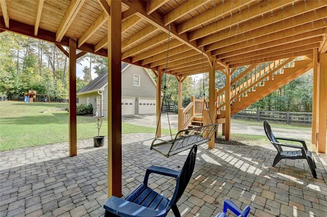 view of patio with a playground and a garage