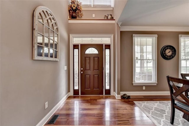 entryway featuring hardwood / wood-style floors and crown molding