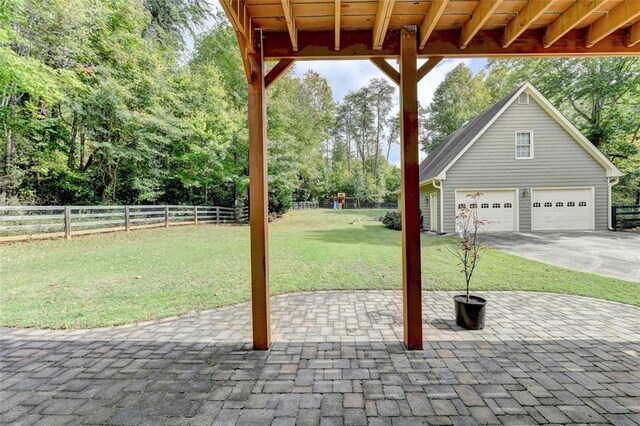 view of patio / terrace featuring an outbuilding and a garage