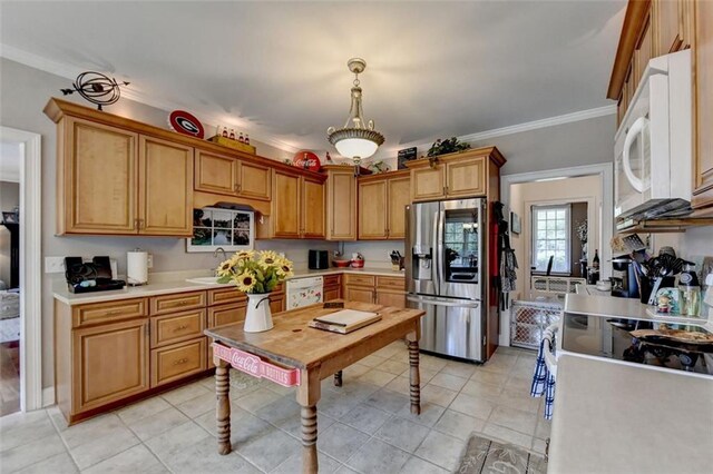 kitchen with white appliances, sink, hanging light fixtures, crown molding, and light tile patterned floors