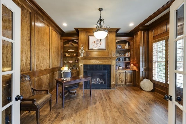 5284 Vernon Springs Trl, Sandy Springs, GA 30327 - office featuring ornamental molding, a tiled fireplace, built in features, wood finished floors, and wooden walls