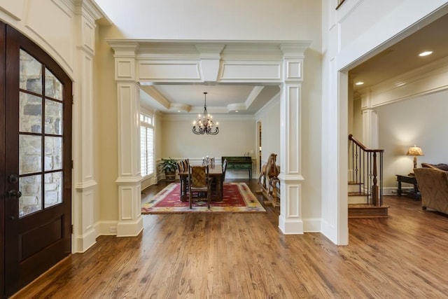 5284 Vernon Springs Trl, Sandy Springs, GA 30327 - dining space featuring wood finished floors, a chandelier, crown molding, stairway, and a decorative wall