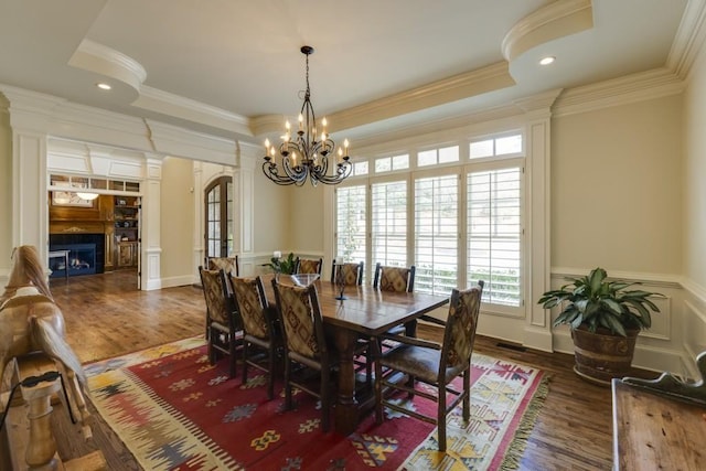 5284 Vernon Springs Trl, Sandy Springs, GA 30327 - dining room featuring a chandelier, wood finished floors, crown molding, a decorative wall, and a fireplace