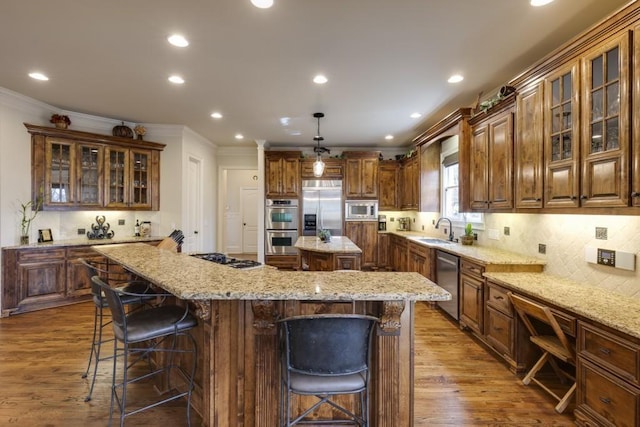 5284 Vernon Springs Trl, Sandy Springs, GA 30327 - kitchen featuring built in appliances, a center island, a kitchen bar, dark wood finished floors, and crown molding