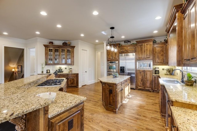 5284 Vernon Springs Trl, Sandy Springs, GA 30327 - kitchen featuring built in appliances, a kitchen island, a sink, ornamental molding, and light wood-type flooring