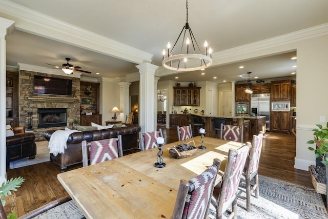 5284 Vernon Springs Trl, Sandy Springs, GA 30327 - dining space with dark wood finished floors, a chandelier, ornamental molding, ceiling fan, and a fireplace