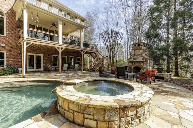 5284 Vernon Springs Trl, Sandy Springs, GA 30327 - view of swimming pool with french doors, an outdoor stone fireplace, a patio, a ceiling fan, and stairway