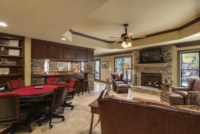 5284 Vernon Springs Trl, Sandy Springs, GA 30327 - living area featuring a tray ceiling, ornamental molding, a fireplace, a ceiling fan, and recessed lighting