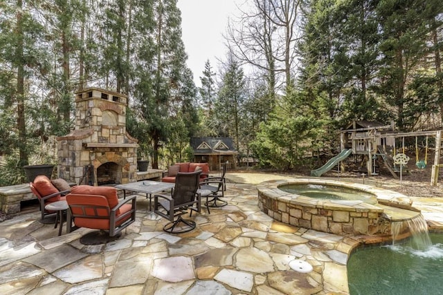 5284 Vernon Springs Trl, Sandy Springs, GA 30327 - view of patio / terrace featuring a playground, view of scattered trees, a pool with connected hot tub, and an outdoor living space with a fireplace