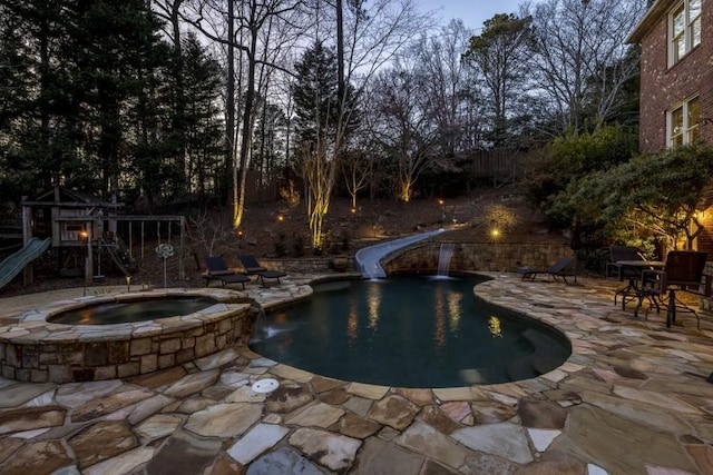 5284 Vernon Springs Trl, Sandy Springs, GA 30327 - view of pool with a patio area, a water slide, a playground, and a pool with connected hot tub