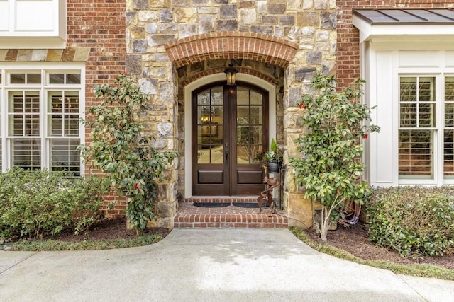 5284 Vernon Springs Trl, Sandy Springs, GA 30327 - property entrance featuring french doors, stone siding, brick siding, and a standing seam roof