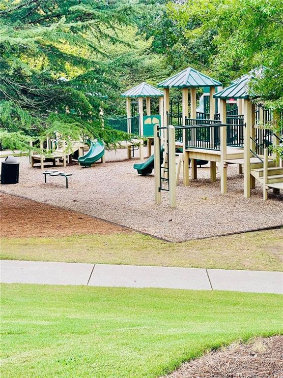 communal playground featuring a lawn