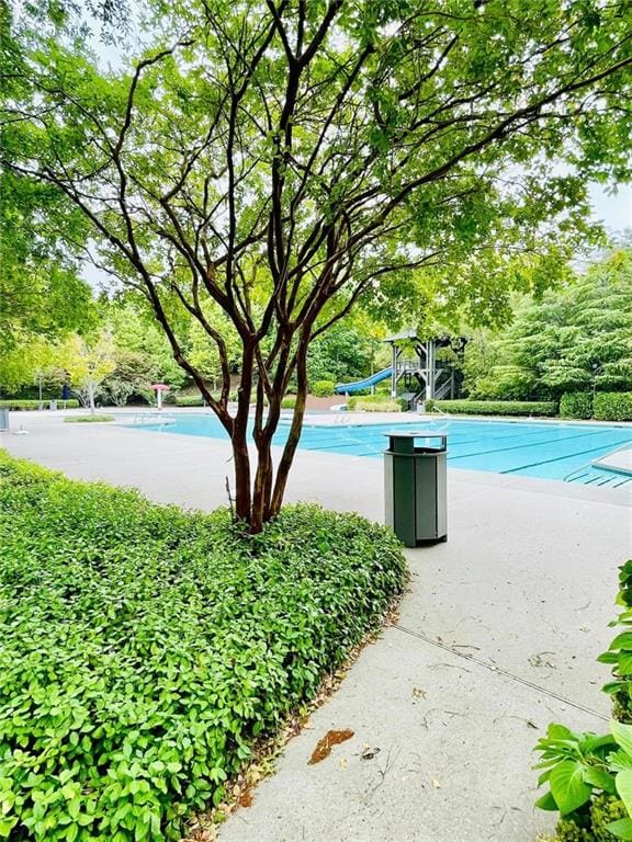 306 Mountain Laurel Walk, Canton, GA 30114 - swimming pool featuring view of wooded area