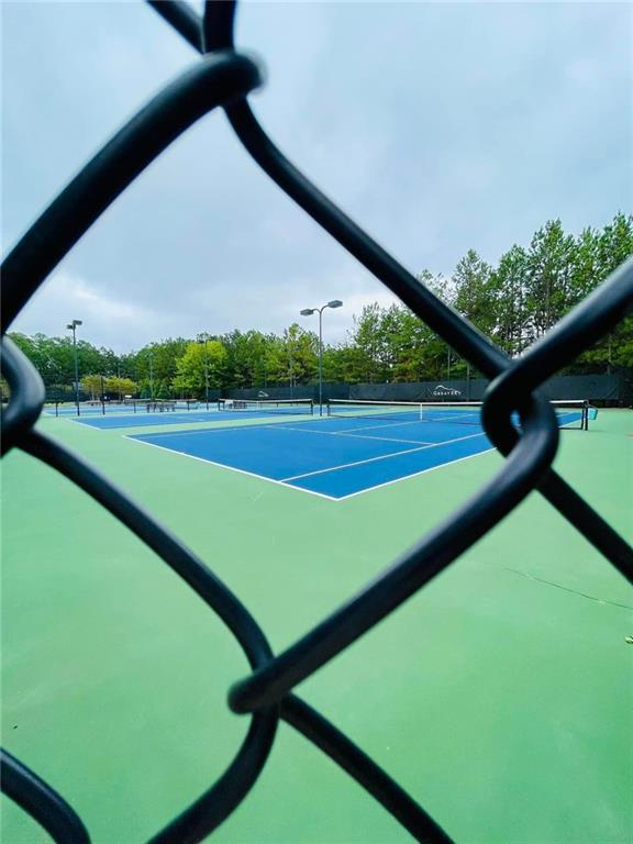 view of tennis court with fence