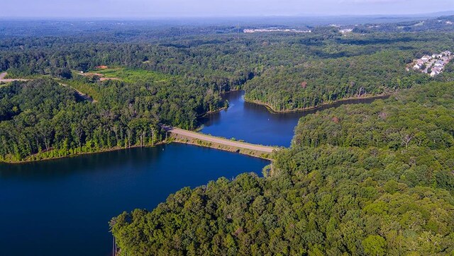 aerial view featuring a water view and a wooded view