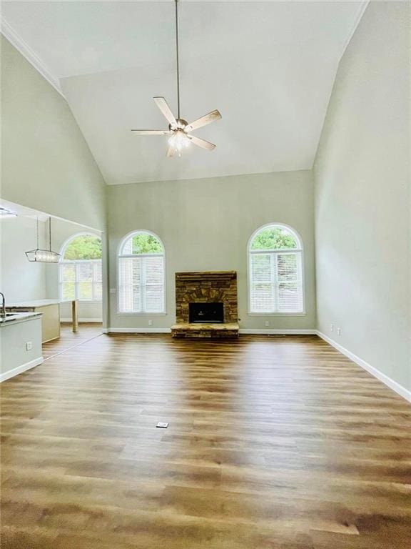 306 Mountain Laurel Walk, Canton, GA 30114 - unfurnished living room featuring high vaulted ceiling, plenty of natural light, ceiling fan, wood finished floors, and a fireplace
