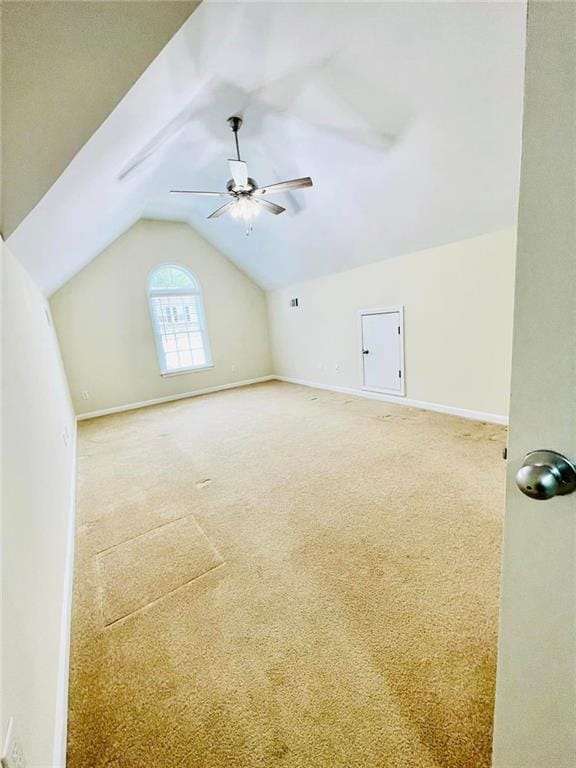 additional living space featuring carpet floors, vaulted ceiling, baseboards, and ceiling fan