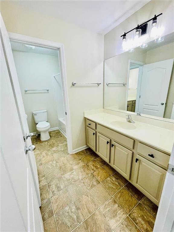 306 Mountain Laurel Walk, Canton, GA 30114 - bathroom with vanity, toilet, shower / tub combination, and baseboards