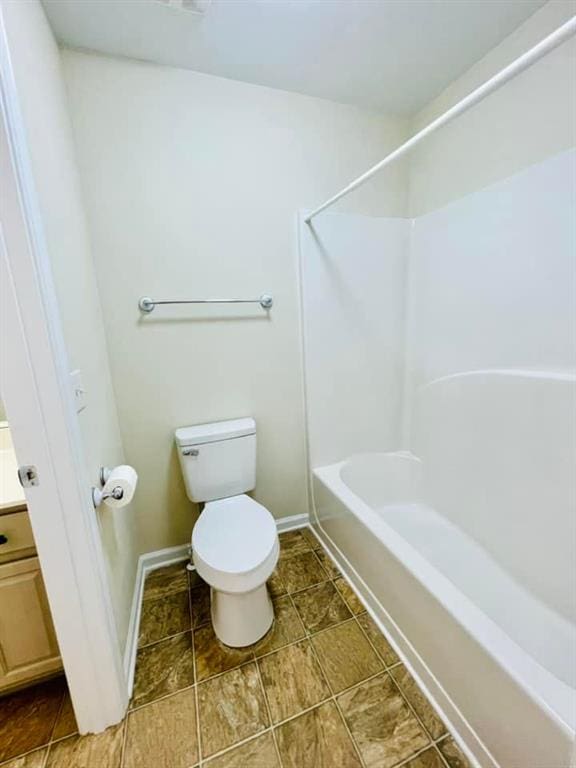 full bath featuring toilet, baseboards, tub / shower combination, and vanity