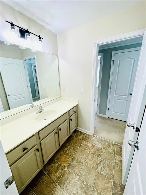 306 Mountain Laurel Walk, Canton, GA 30114 - bathroom with vanity, baseboards, and stone finish flooring