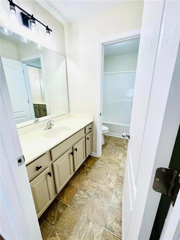 306 Mountain Laurel Walk, Canton, GA 30114 - bathroom with vanity, toilet, and a tub