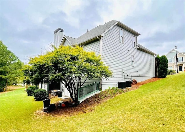 view of property exterior with a lawn and a chimney