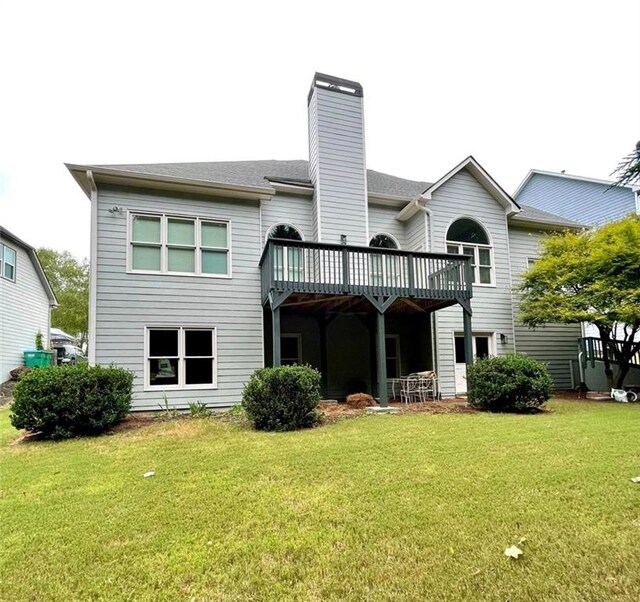 back of house with a yard and a wooden deck