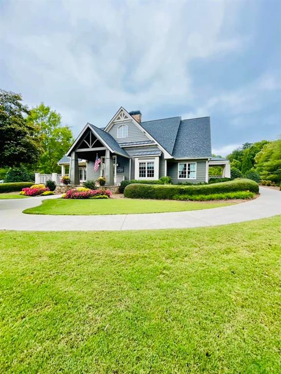 view of front of home with a chimney and a front yard