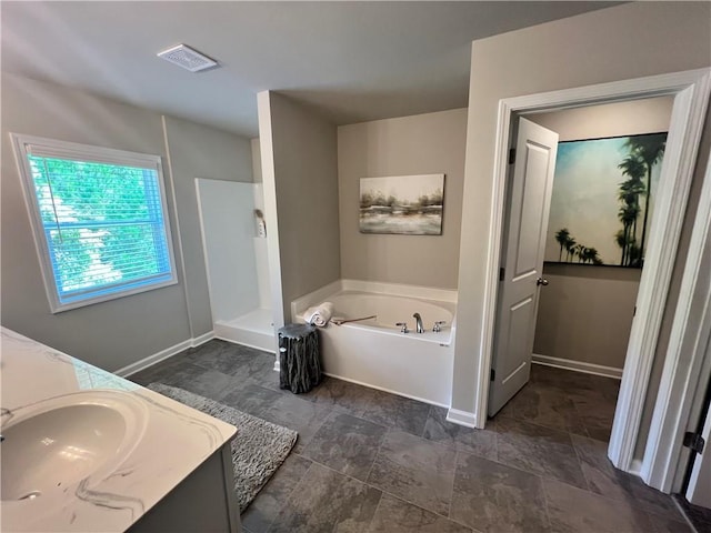 bathroom with vanity and independent shower and bath