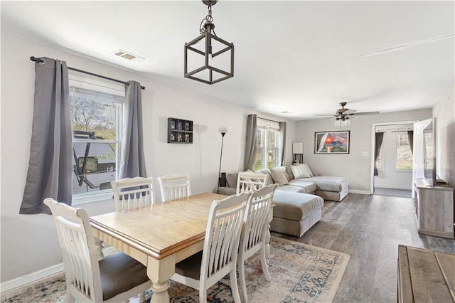 dining area featuring a healthy amount of sunlight, a ceiling fan, and wood finished floors