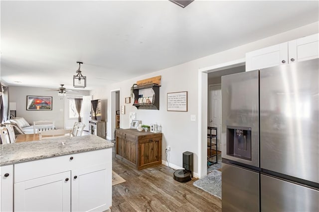 kitchen featuring dark wood-type flooring, stainless steel refrigerator with ice dispenser, open floor plan, white cabinetry, and ceiling fan