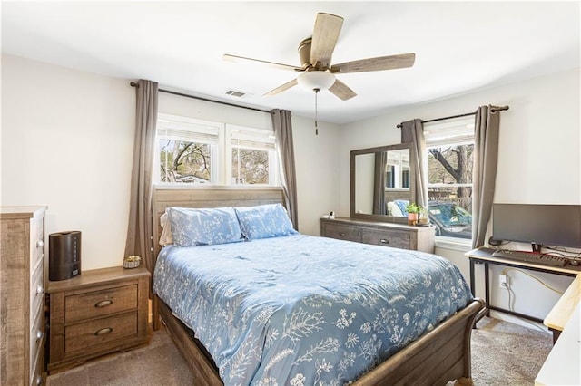 bedroom featuring visible vents, ceiling fan, and carpet