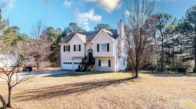 bi-level home with a front lawn and a garage