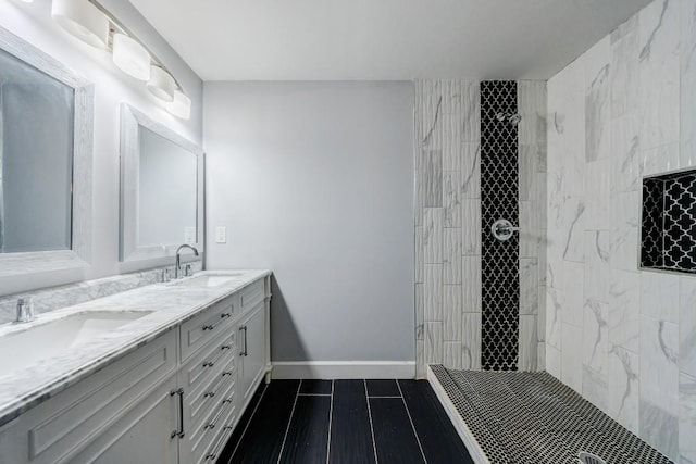 bathroom featuring vanity, wood-type flooring, and a tile shower