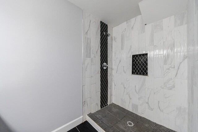 bathroom with a tile shower