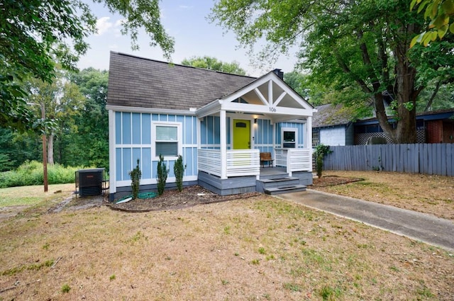 view of front facade featuring central AC unit, a front yard, and a porch