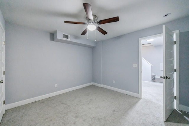 empty room featuring light carpet and ceiling fan