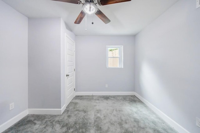 empty room featuring ceiling fan and light carpet