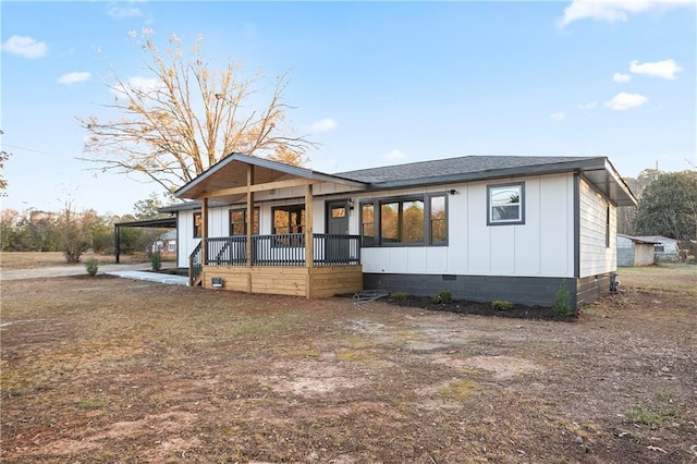 4605 Doss Cir, Powder Springs, GA 30127 - rear view of property featuring covered porch, a shingled roof, board and batten siding, crawl space, and driveway