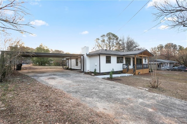 4605 Doss Cir, Powder Springs, GA 30127 - view of front of property with a porch, a carport, a chimney, and aphalt driveway