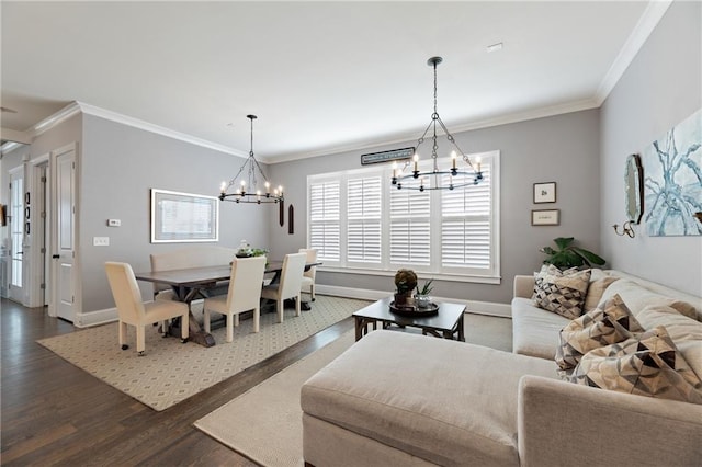 living room featuring ornamental molding, dark wood-type flooring, and a chandelier