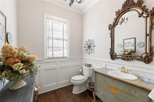 bathroom featuring toilet, a healthy amount of sunlight, wood-type flooring, and crown molding